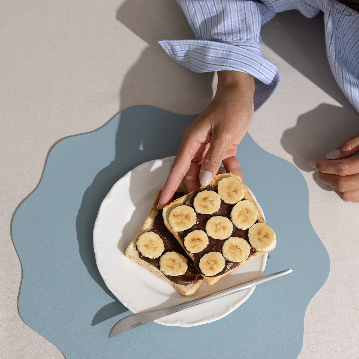 FRANKY'S Seville Placemat in Light Blue, served with the Peru Cutley Set in Silver